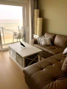 a living room with a couch and a coffee table at Bianca in Middelkerke