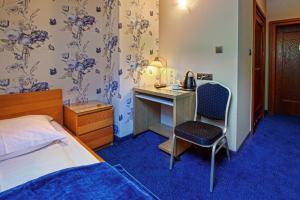 Posteľ alebo postele v izbe v ubytovaní Hotel Zalesie