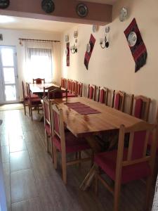 a dining room with a wooden table and chairs at Casa Ardeleneasca in Sebeşu de Sus