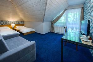 Posteľ alebo postele v izbe v ubytovaní Hotel Zalesie