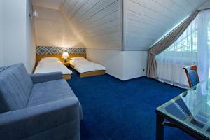 Posteľ alebo postele v izbe v ubytovaní Hotel Zalesie