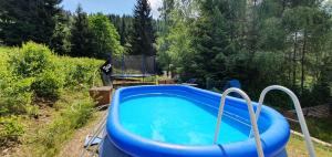 a swimming pool in a yard with at Pension Renata in Harrachov