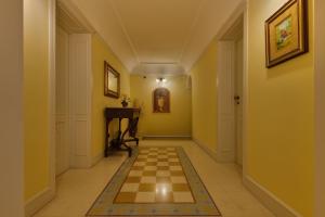 a hallway with a checkerboard floor in a house at Casa Manzella in Terrasini