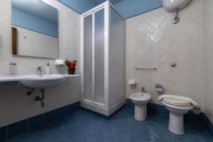 a bathroom with a toilet and a sink at Casa Manzella in Terrasini