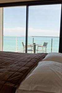 a bedroom with a bed and a view of the ocean at Villa Azur in Villeneuve-Loubet