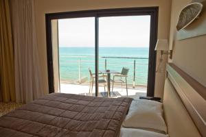 a bedroom with a bed and a view of the ocean at Villa Azur in Villeneuve-Loubet