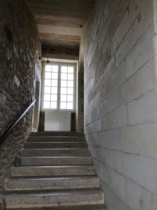 een trap in een oud gebouw met een raam bij Château de la Garnison in Orvault