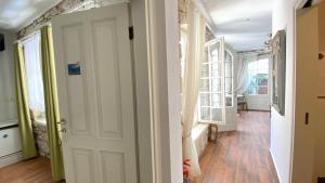a hallway with a door and a room with windows at Oberj d'Azur Alaçatı in Alaçatı