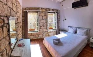 a bedroom with a large bed and two windows at Oberj d'Azur Alaçatı in Alaçatı