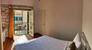 a bedroom with a bed and a balcony with a table at Oberj d'Azur Alaçatı in Alaçatı