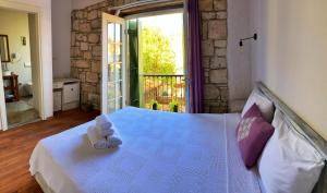 a bedroom with a bed with towels on it at Oberj d'Azur Alaçatı in Alaçatı