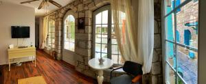 a room with a sink and a stone wall at Oberj d'Azur Alaçatı in Alacati