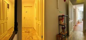 a hallway with a white door and a room with a floor at Oberj d'Azur Alaçatı in Alaçatı