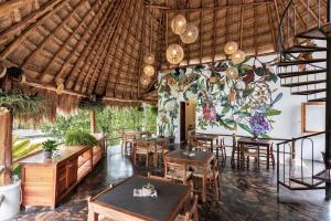 a living room filled with furniture and plants at Hotel Aires Bacalar in Bacalar