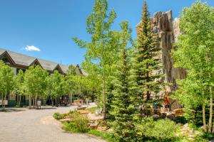 a street with trees in front of a building at Peregrine in Copper Mountain
