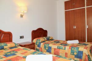 Postel nebo postele na pokoji v ubytování Apartaments Les Dunes