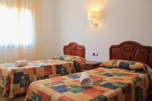 Postel nebo postele na pokoji v ubytování Apartaments Les Dunes