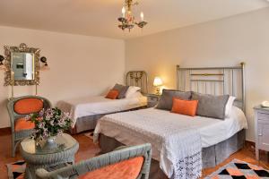 a hotel room with two beds and a chair at Finca Hotel Los Girasoles in Montenegro +48 photos