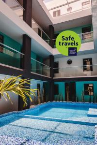 a view of a building with a large swimming pool at Hotel Flamingo Merida in Mérida