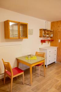 a small kitchen with a table and two chairs at Haus Alpenrose in Obertraun