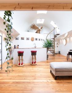a living room with a staircase and wooden floors at B&B Houseboat Amsterdam in Amsterdam