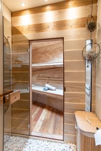 a sauna with a glass wall in a bathroom at B&B Houseboat Amsterdam in Amsterdam