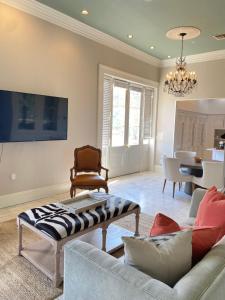 a living room filled with furniture and a large window at French Quarter 3 Bedroom Condo with Balcony in New Orleans
