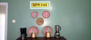 a wall with plates on a blue wall at Kwetu Home - Sagana PAY BEFORE ARRIVAL in Sagana