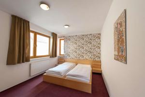 Posteľ alebo postele v izbe v ubytovaní Hotel Garni Pod Skalkou