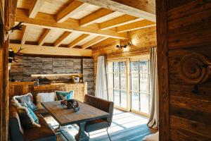 a dining room with a table in a log cabin at Chalet Zugspitztraum in Ehrwald