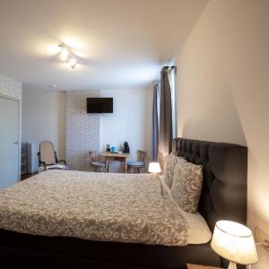 Posteľ alebo postele v izbe v ubytovaní B&B De Bloesem