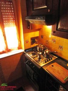 a kitchen with a stove with pots and pans on it at B&B Historic Centre Naples in Naples