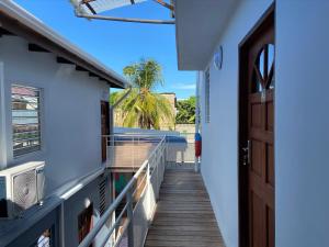 a hallway leading to a house with a door at Kayenn’Apparts in Cayenne