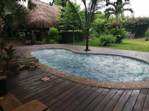 a swimming pool on a deck with a wooden floor at Chez Oliv in Palomino