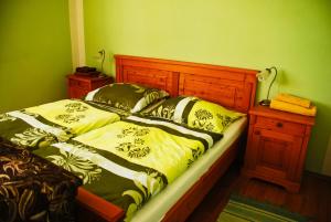 a bedroom with two beds and a wooden headboard at Hostinec a penzion U Rezků in Jistebnice