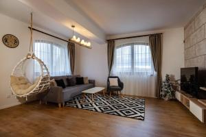 a living room with a couch and a swing at GOLDENapartment in Veľká Lomnica