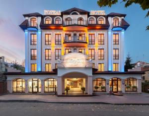 a hotel with a large white building at Nota Bene Hotel & Restaurant in Lviv