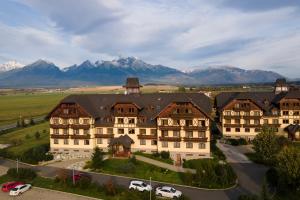 an aerial view of a hotel with mountains in the background at GOLDENapartment in Veľká Lomnica