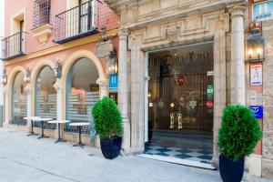 a store with two potted plants in front of a building at Hotel Doña María in Seville