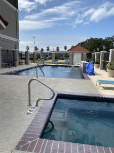 a large swimming pool in the middle of a building at Quality Inn and Suites in Rosenberg +15 photos