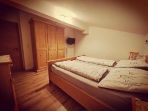 two twin beds in a room with wooden floors at Apartments Kitzbühel in Kitzbühel