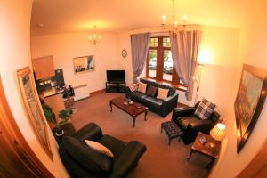 a living room with couches and chairs at Glenfiddich in Nairn