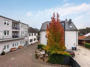an apartment complex with a tree in a courtyard at Nice studio near Luxembourg in Bollendorf