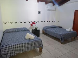 Ένα ή περισσότερα κρεβάτια σε δωμάτιο στο Hotel Posada Comala