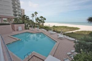 a large swimming pool next to a beach at 12B Crescent Beach Club in Clearwater Beach