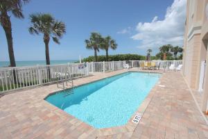 a swimming pool with the ocean in the background at Sun & Sea C300 in Clearwater Beach