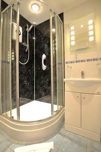 a bathroom with a shower and a sink at The Old Bridge House in Looe