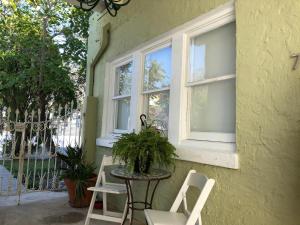 a table and chairs on a porch with two windows at Private Studio with Free Parking - 7G in Miami