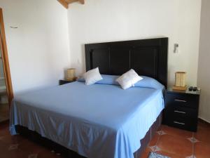Ένα ή περισσότερα κρεβάτια σε δωμάτιο στο Hotel Posada Comala