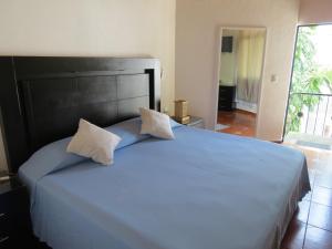 Ένα ή περισσότερα κρεβάτια σε δωμάτιο στο Hotel Posada Comala